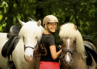 Reiterin mit zwei Pferden